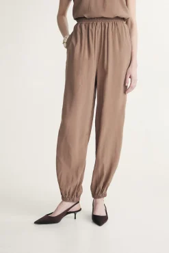 Fluid pants with fitted ankles